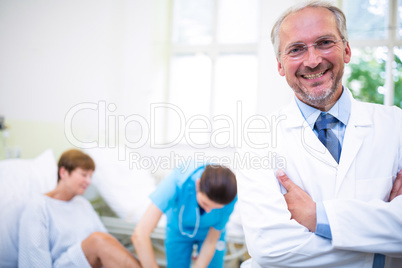 Smiling doctor standing with arms crossed Smiling doctor standing with arms crossed