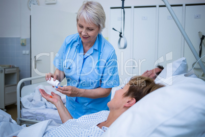 Nurse giving medication to patient