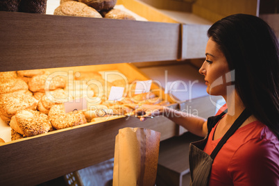 Female baker packing sweet food