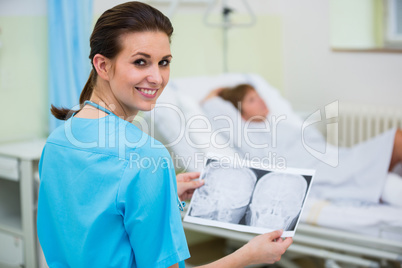 Nurse holding a x-ray in hospital ward
