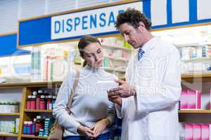 Pharmacist assisting the medicine to customer