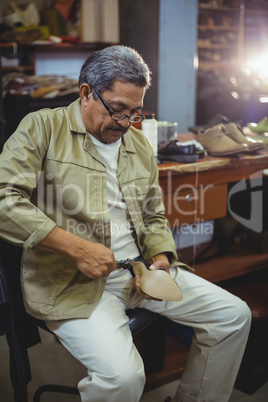 Shoemaker repairing a high heel