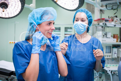 Female surgeon interacting with each other in corridor