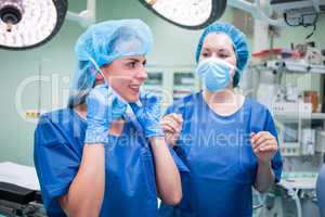 Female surgeon interacting with each other in corridor