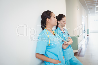 Sad nurse leaning against the wall