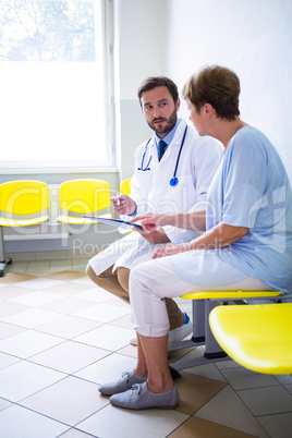 Doctor consulting patient in waiting room
