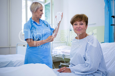 Portrait of smiling patient sitting on bed