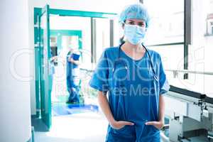 Portrait of female surgeon standing in corridor