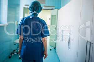 Surgeon standing in corridor at hospital