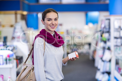 Customer holding a medicine box in pharmacy