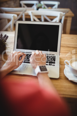 Hands of woman using laptop