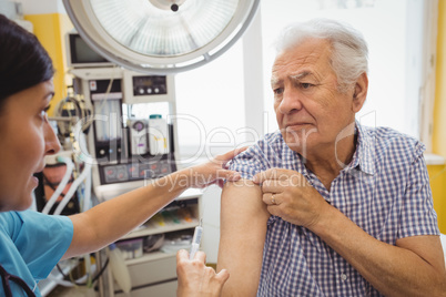 Female doctor giving an injection to a patient