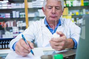 Pharmacist writing prescriptions for medicines