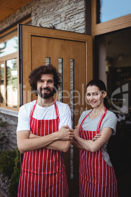 Portrait of couple standing with arms crossed