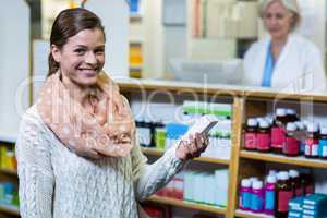 Customer holding a medicine box in pharmacy