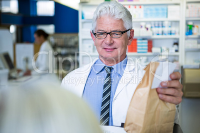 Pharmacist holding a medicine package