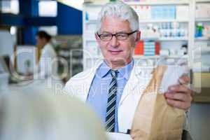 Pharmacist holding a medicine package