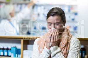 Customer covering her nose while sneezing