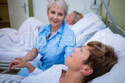 Nurse examining patients pulse
