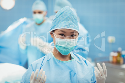 Portrait of female surgeon preparing for operation in operation