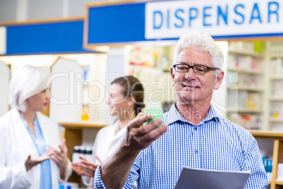 Customer holding prescription while checking medicine