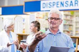 Customer holding prescription while checking medicine