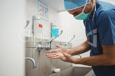 Male surgeon washing his hands