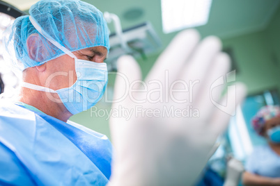 Surgeon preparing for operation in operation room