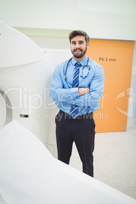 Portrait of doctor standing near mri scanner