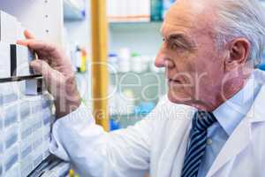 Pharmacist checking medicines