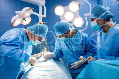 Surgeons performing operation in operation room
