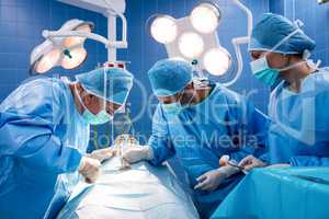 Surgeons performing operation in operation room