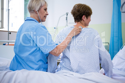 Nurse examining a patient with a stethoscope