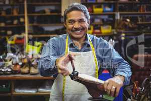 Shoemaker repairing a shoe