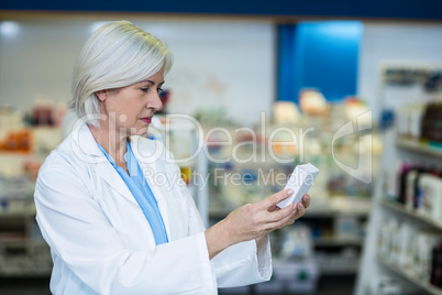 Pharmacist checking a medicine box