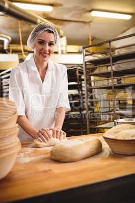 Female baker kneading a dough