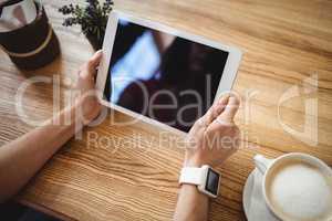 Hands of woman using digital tablet