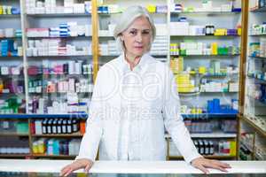 Pharmacist standing at counter