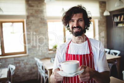 Male baker holding a cup of coffee