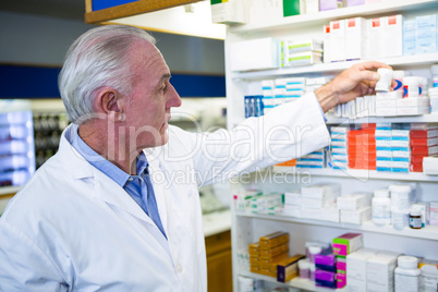 Pharmacist checking a bottle of drug