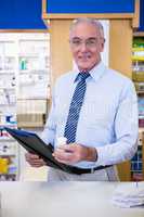 Pharmacist holding a medicine container and clipboard