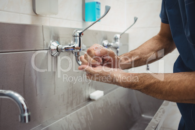 Male surgeon washing his hands