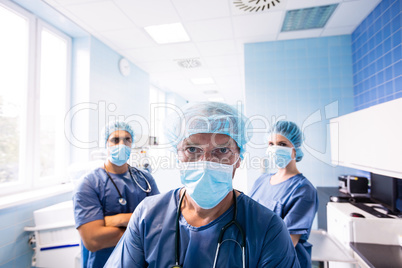 Surgeon and nurses standing in hospital