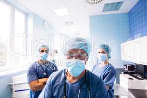 Surgeon and nurses standing in hospital