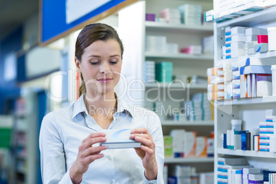 Pharmacist checking a medicine box