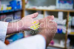 Pharmacist holding a packet of tablets