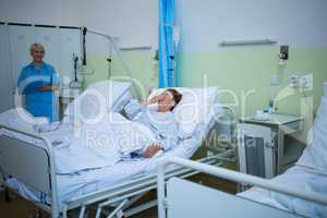 Senior patient laughing while lying on a bed