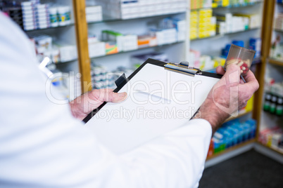 Pharmacist checking medicines