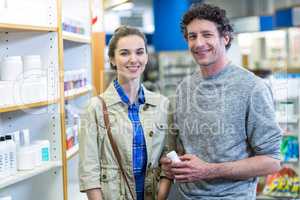 Couple holding a medicine box in pharmacy