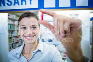 Pharmacist checking a capsule